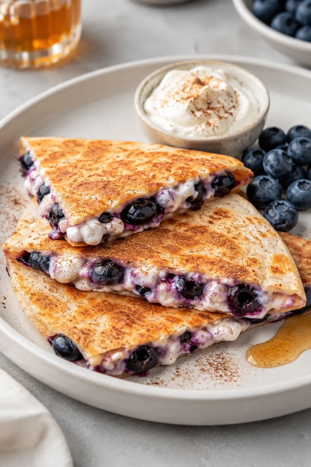 Blueberry breakfast quesadilla wedges with creamy filling and fresh blueberries