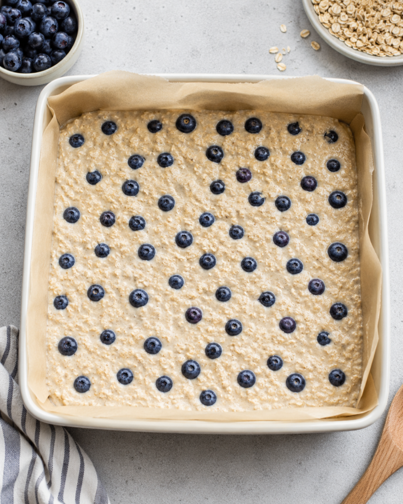 Blueberry cottage cheese breakfast bake batter spread in a square baking dish before baking