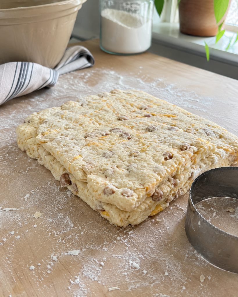 Folded biscuit dough ready to cut for fluffy breakfast protein biscuits